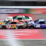 NASCAR Cup Series drivers Chase Briscoe (19) Ryan Preece (60) and Shane van Gisbergen (88) race bumper to bumper down the main straightaway during stage three of the FireKeepers Casino 400 at Michigan International Speedway.
