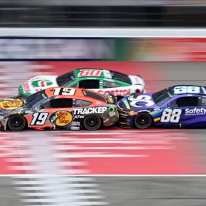 NASCAR Cup Series drivers Chase Briscoe (19) Ryan Preece (60) and Shane van Gisbergen (88) race bumper to bumper down the main straightaway during stage three of the FireKeepers Casino 400 at Michigan International Speedway.