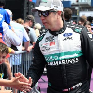 NASCAR Cup Series driver Brad Keselowski (6) greets the crowd during driver introductions before the start of the FireKeepers Casino 400 at Michigan International Speedway.
