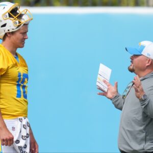 Los Angeles Chargers quarterback Justin Herbert (10) interacts with offensive coordinator Greg Roman during minicamp at the Hoag Performance Center.