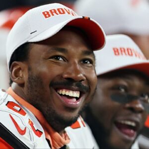 Cleveland Browns defensive end Myles Garrett (left) laughs as he watches a video on the scoreboard during a preseason game against Washington on Aug. 8, 2019, in Cleveland, Ohio.