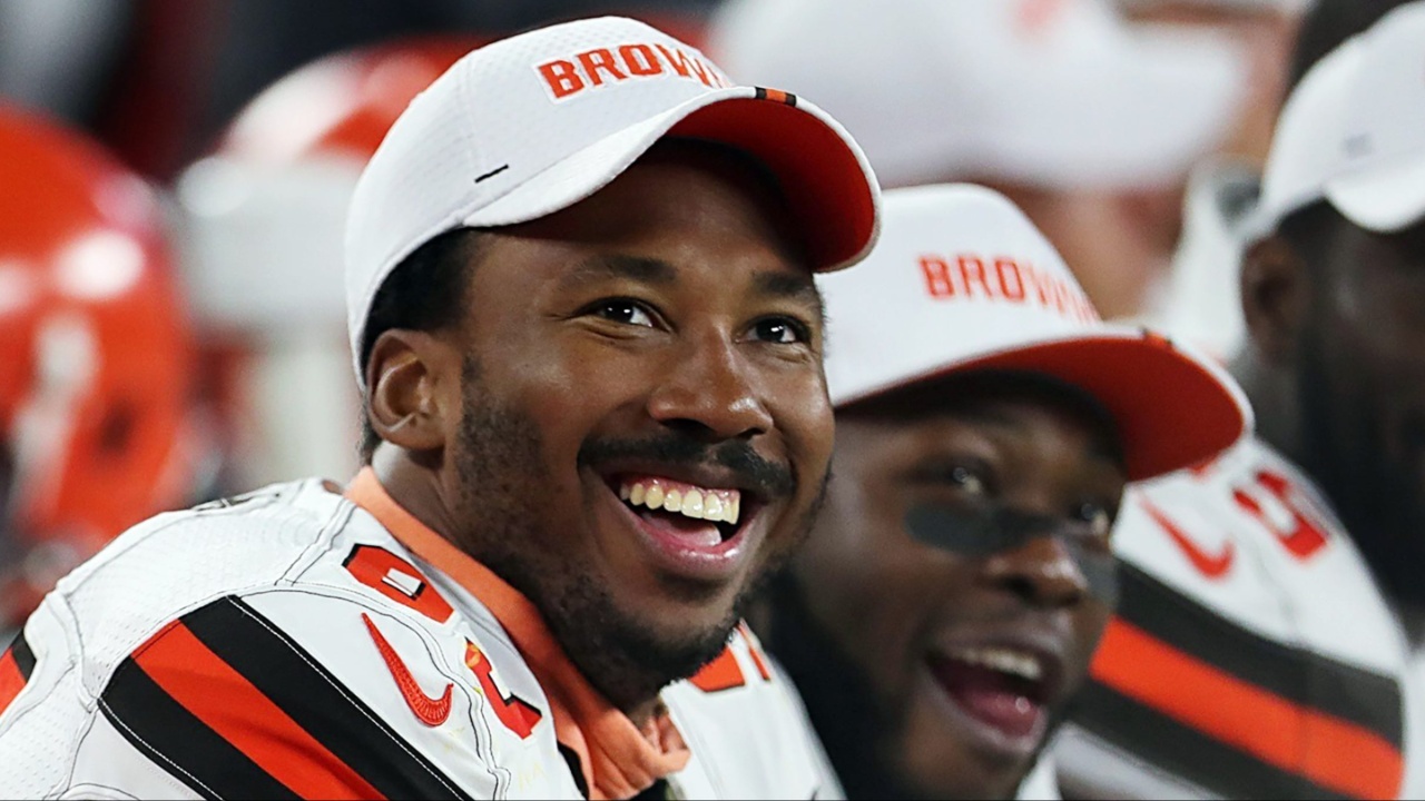 Cleveland Browns defensive end Myles Garrett (left) laughs as he watches a video on the scoreboard during a preseason game against Washington on Aug. 8, 2019, in Cleveland, Ohio.