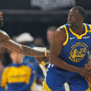 Dec 25, 2024; San Francisco, California, USA; Golden State Warriors forward Draymond Green (right) handles the ball against Los Angeles Lakers forward LeBron James (left) during the first quarter at Chase Center.