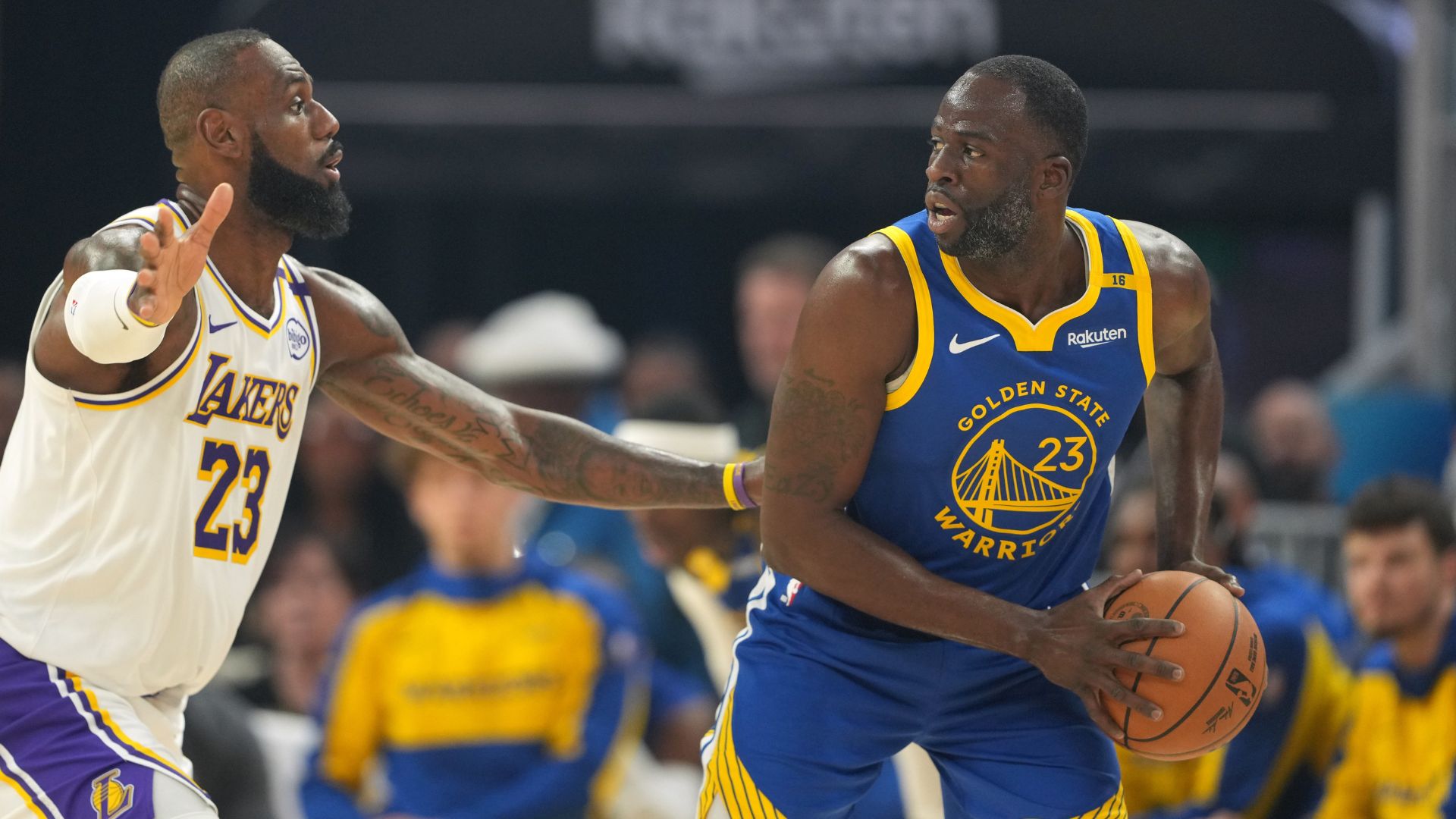 Dec 25, 2024; San Francisco, California, USA; Golden State Warriors forward Draymond Green (right) handles the ball against Los Angeles Lakers forward LeBron James (left) during the first quarter at Chase Center.
