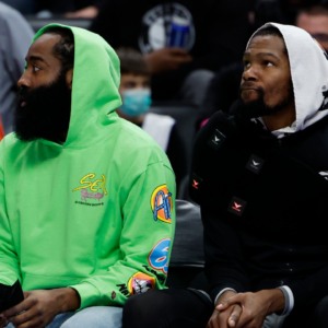 Brooklyn Nets guard James Harden (left) and forward Kevin Durant (right) sit on the bench in the first half against the Detroit Pistons