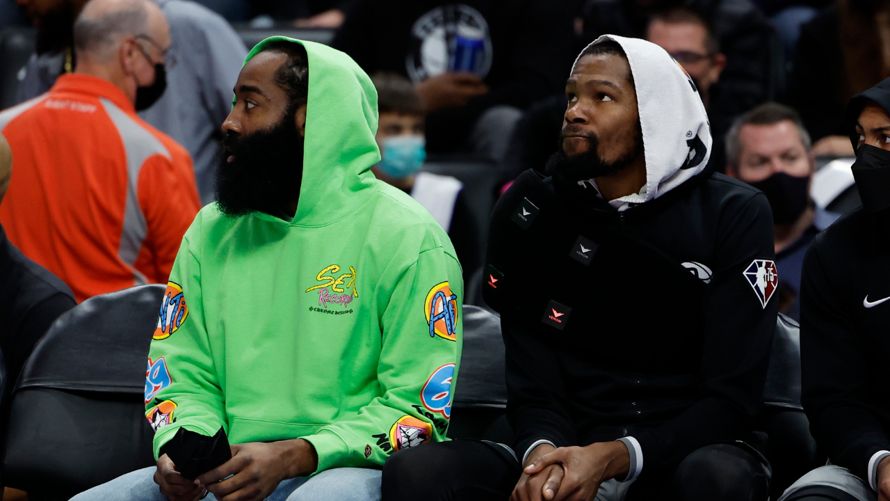 Brooklyn Nets guard James Harden (left) and forward Kevin Durant (right) sit on the bench in the first half against the Detroit Pistons