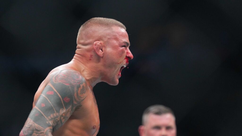 Dustin Poirier (blue gloves) reacts during the fight against Islam Makhachev (red gloves) during UFC 302 at Prudential Center.