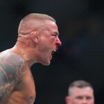 Dustin Poirier (blue gloves) reacts during the fight against Islam Makhachev (red gloves) during UFC 302 at Prudential Center.