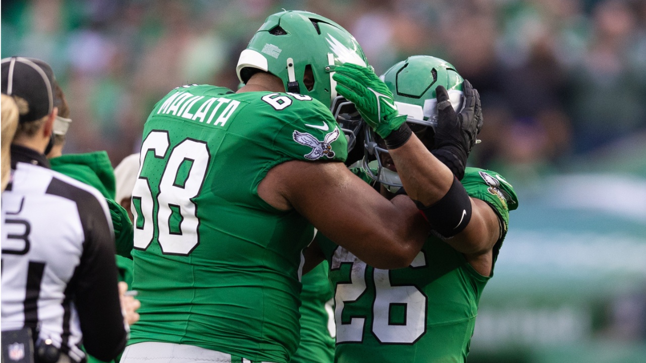 Philadelphia Eagles running back Saquon Barkley (26) celebrates with offensive tackle Jordan Mailata (68) after rushing for 167 yards in a game against the Dallas Cowboys at Lincoln Financial Field.