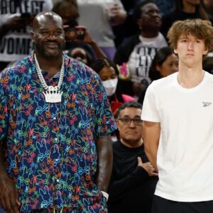 Former NBA player Shaquille O'Neal and Chicago Bulls 2024 NBA draft pick Matas Buzelis stand on the sidelines before a basketball game between the Chicago Sky and Indiana Fever at Wintrust Arena.