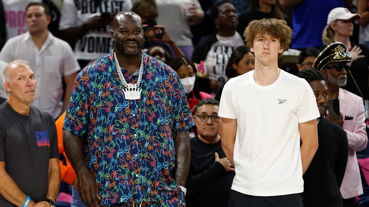 Former NBA player Shaquille O'Neal and Chicago Bulls 2024 NBA draft pick Matas Buzelis stand on the sidelines before a basketball game between the Chicago Sky and Indiana Fever at Wintrust Arena.