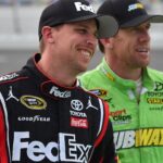 NASCAR Sprint Cup Series driver Denny Hamlin (L) and Carl Edwards (R) look on during qualifying for the Coke Zero 400 powered by Coca-Cola at Daytona International Speedway.