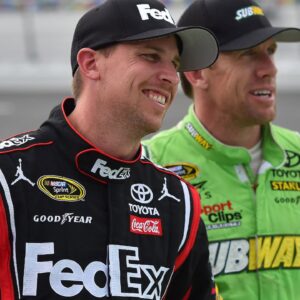 NASCAR Sprint Cup Series driver Denny Hamlin (L) and Carl Edwards (R) look on during qualifying for the Coke Zero 400 powered by Coca-Cola at Daytona International Speedway.
