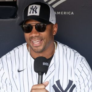 New York Giants quarterback Russell Wilson is interviewed prior to the game between the New York Mets and the New York Yankees at Yankee Stadium.