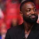 Jan 14, 2024; Miami, Florida, USA; Former Miami Heat player Dwayne Wade reacts after learning a statue will be erected outside of Kaseya Center in 2025, during a special ceremony during halftime of the game between the Miami Heat and the Charlotte Hornets