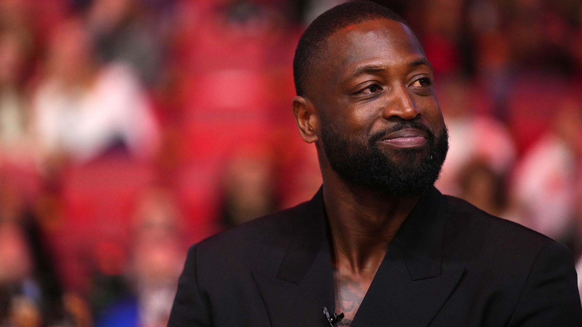 Jan 14, 2024; Miami, Florida, USA; Former Miami Heat player Dwayne Wade reacts after learning a statue will be erected outside of Kaseya Center in 2025, during a special ceremony during halftime of the game between the Miami Heat and the Charlotte Hornets