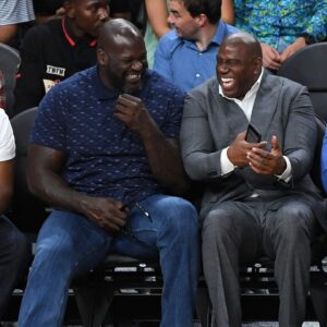 NBA Hall of Famers Shaquille O'Neal and Magic Johnson share a laugh during the second half between the Los Angeles Lakers and the Golden State Warriors at T-Mobile Arena.