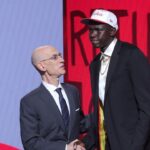 Khaman Maluach stands with NBA commissioner Adam Silver after being selected as the tenth pick by the Houston Rockets in the first round of the 2025 NBA Draft at Barclays Center