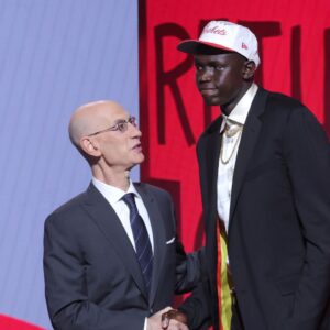 Khaman Maluach stands with NBA commissioner Adam Silver after being selected as the tenth pick by the Houston Rockets in the first round of the 2025 NBA Draft at Barclays Center