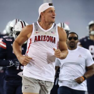 Rob Gronkowski leads the team onto the field as the honorary captain during the first half at Arizona Stadium.