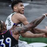 Milwaukee Bucks forward Giannis Antetokounmpo (34) takes a shot against Philadelphia 76ers center Dwight Howard (39) in the first quarter at Fiserv Forum.