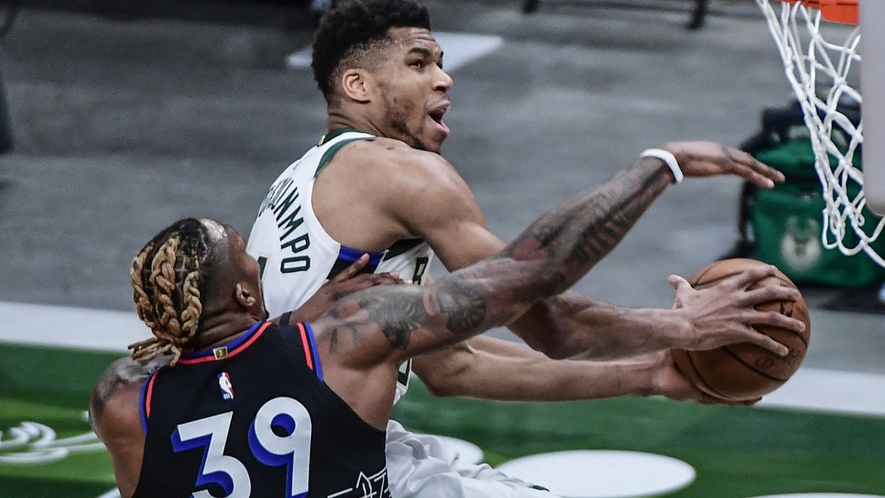 Milwaukee Bucks forward Giannis Antetokounmpo (34) takes a shot against Philadelphia 76ers center Dwight Howard (39) in the first quarter at Fiserv Forum.