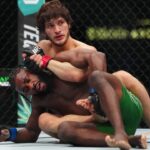 Movsar Evloev (red gloves) fights Aljamain Streling (blue gloves) at T-Mobile Arena.