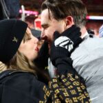 Recording artist Taylor Swift and Kansas City Chiefs tight end Travis Kelce (87) react after the AFC Championship game against the Buffalo Bills at GEHA Field at Arrowhead Stadium.