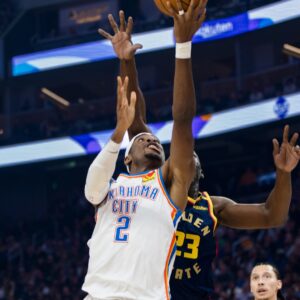 Nov 27, 2024; San Francisco, California, USA; Oklahoma City Thunder guard Shai Gilgeous-Alexander (2) shoots as Golden State Warriors forward Draymond Green (23) defends during the first half at Chase Center