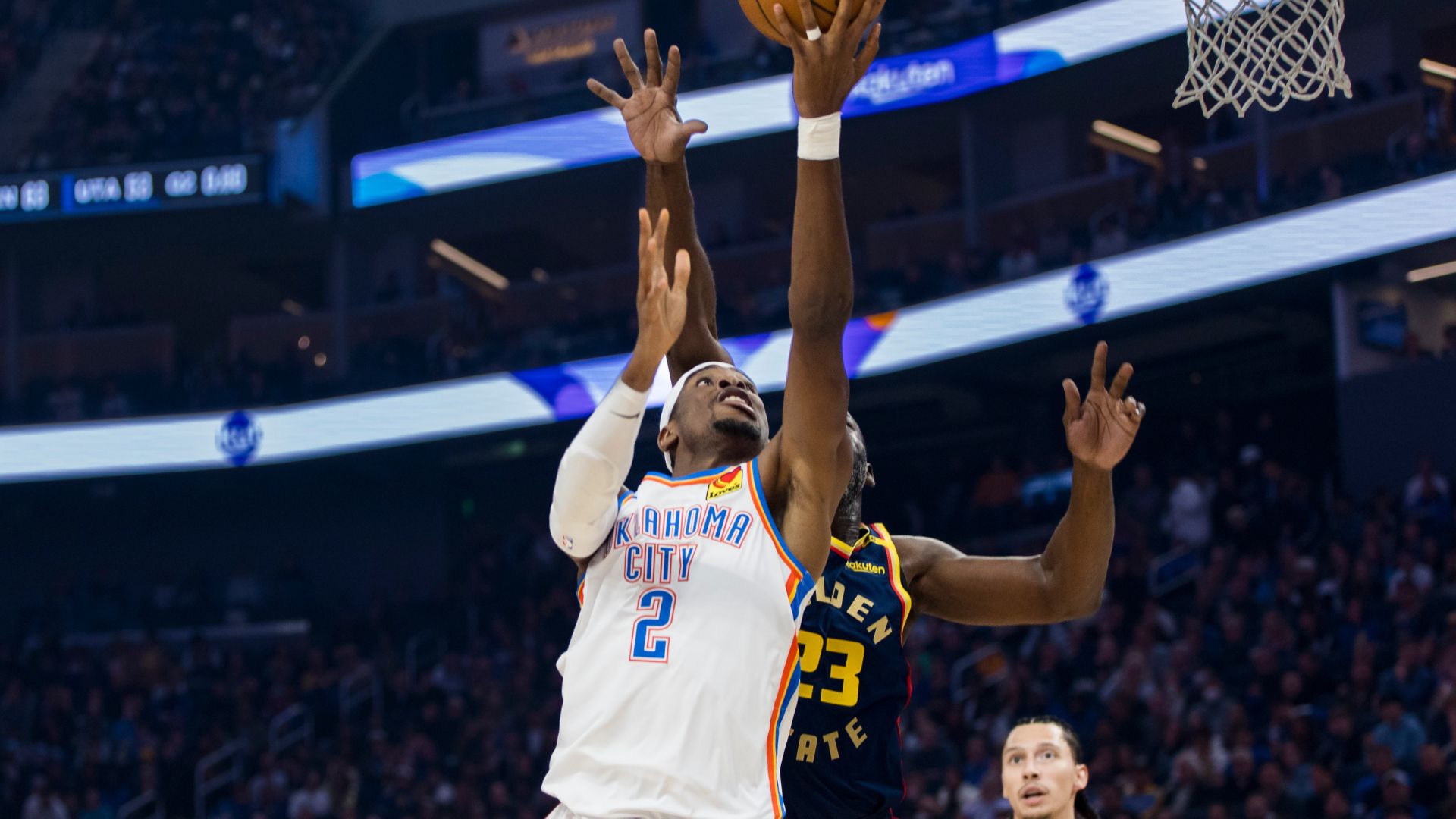 Nov 27, 2024; San Francisco, California, USA; Oklahoma City Thunder guard Shai Gilgeous-Alexander (2) shoots as Golden State Warriors forward Draymond Green (23) defends during the first half at Chase Center