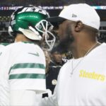 New York Jets quarterback Aaron Rodgers (8) and Pittsburgh Steelers head coach Mike Tomlin (right) greet each other after their game at Acrisure Stadium.