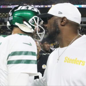 New York Jets quarterback Aaron Rodgers (8) and Pittsburgh Steelers head coach Mike Tomlin (right) greet each other after their game at Acrisure Stadium.