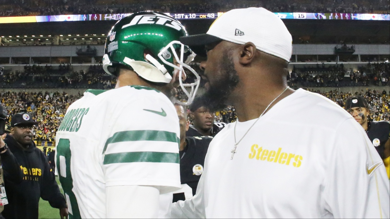 New York Jets quarterback Aaron Rodgers (8) and Pittsburgh Steelers head coach Mike Tomlin (right) greet each other after their game at Acrisure Stadium.