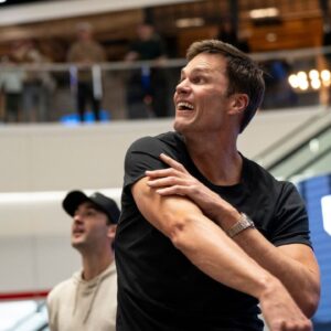 Tom Brady throws a football to a fan at American Dream during the grand opening of Card Vault by Tom Brady, a sports card and memorabilia retailer, East Rutherford, Friday, Apr. 11, 2025.
