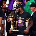 Los Angeles Lakers forward LeBron James (23) smiles while holding the MVP and Finals trophies after game six of the 2020 NBA Finals at AdventHealth Arena. The Los Angeles Lakers won 106-93 to win the series.