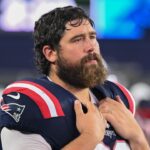New England Patriots center David Andrews (60) watches from the sideline during the first half against the Carolina Panthers at Gillette Stadium.