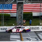 Denny Hamlin (11) crosses the finish line to win the Pocono 350 Cup Series at Pocono Raceway.