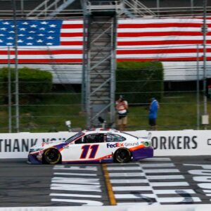 Denny Hamlin (11) crosses the finish line to win the Pocono 350 Cup Series at Pocono Raceway.