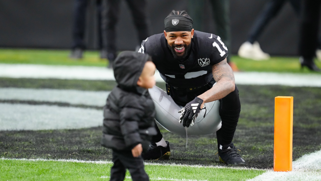 Jan 5, 2025; Paradise, Nevada, USA; Las Vegas Raiders cornerback Jack Jones (18) plays with his son before the start of a game against the Los Angeles Chargers at Allegiant Stadium. Mandatory Credit: Stephen R. Sylvanie-Imagn Images