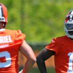 Cleveland Browns quarterback Shedeur Sanders (12) watches quarterback Dillon Gabriel (5) during day two of NFL rookie minicamp at the Cleveland Browns training facility on Saturday, May 10, 2025, in Berea, Ohio.