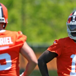 Cleveland Browns quarterback Shedeur Sanders (12) watches quarterback Dillon Gabriel (5) during day two of NFL rookie minicamp at the Cleveland Browns training facility on Saturday, May 10, 2025, in Berea, Ohio.