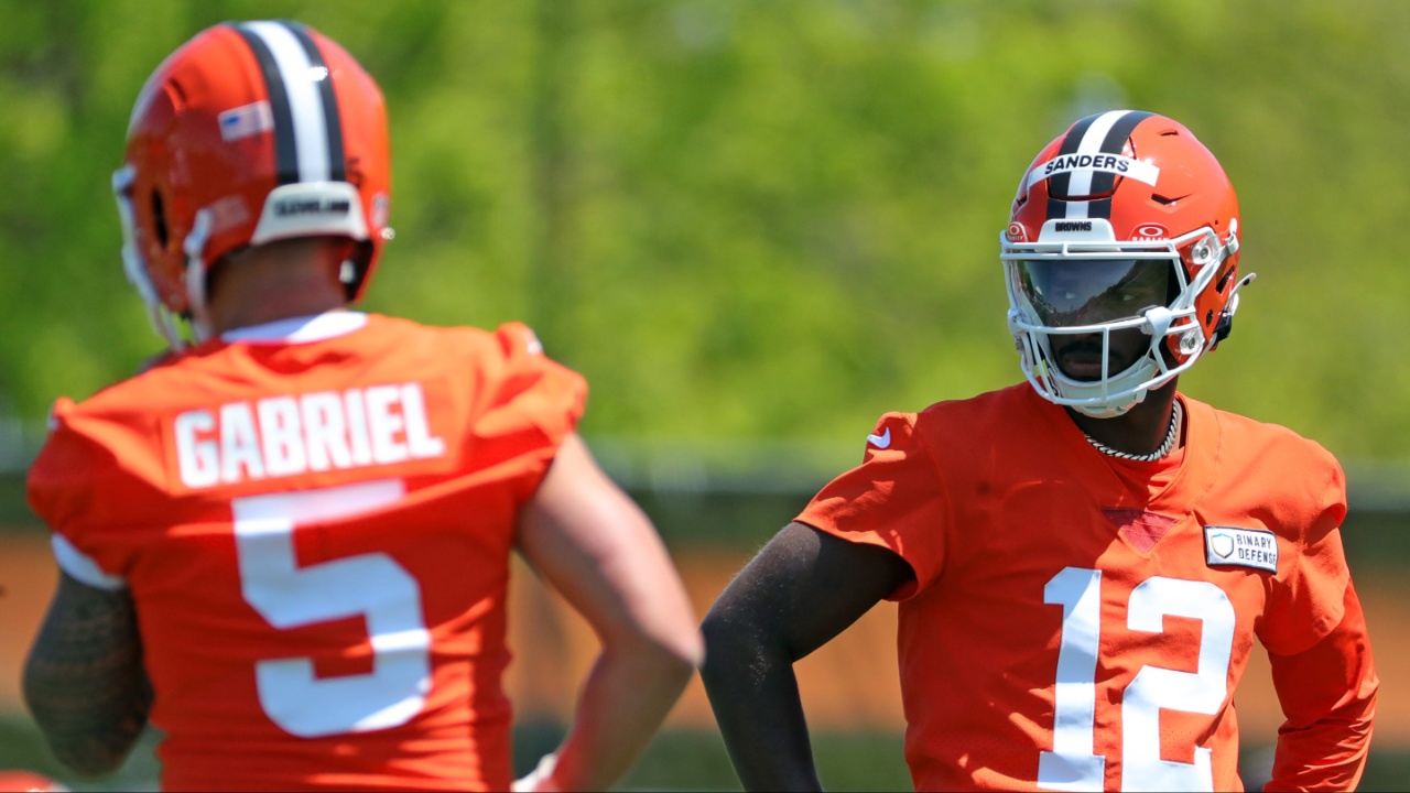 Cleveland Browns quarterback Shedeur Sanders (12) watches quarterback Dillon Gabriel (5) during day two of NFL rookie minicamp at the Cleveland Browns training facility on Saturday, May 10, 2025, in Berea, Ohio.