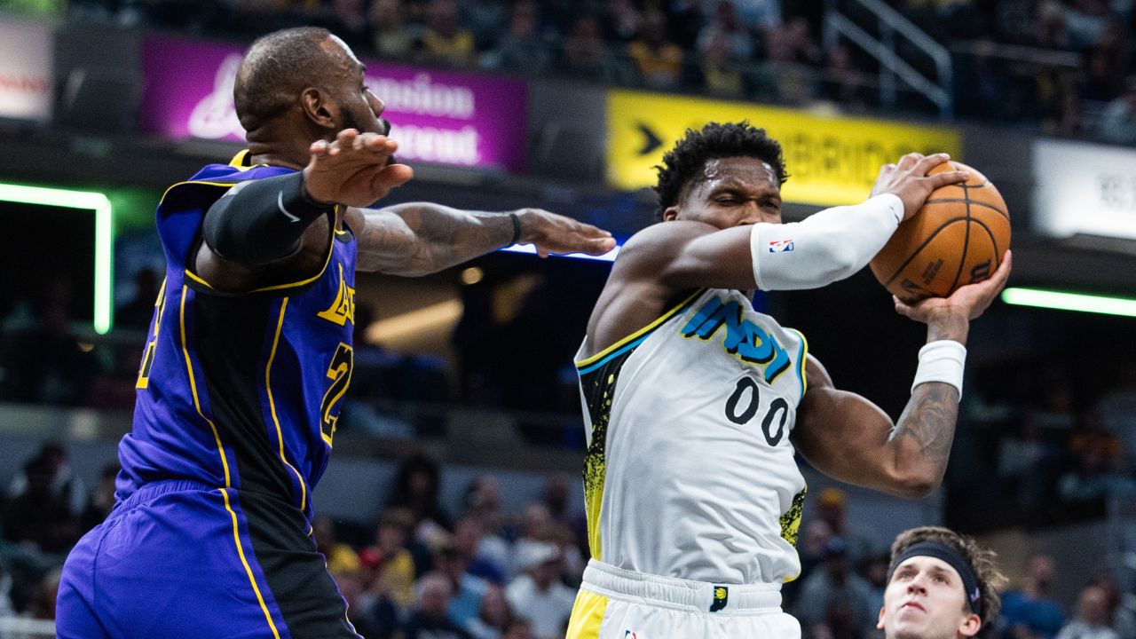 ndiana Pacers guard Bennedict Mathurin (00) shoots the ball while Los Angeles Lakers forward LeBron James (23) defends in the first half at Gainbridge Fieldhouse.