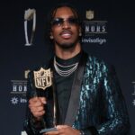 Washington Commanders quarterback Jayden Daniels poses with the Offensive Rookie of the Year award during Super Bowl LIX NFL Honors at Saenger Theatre.