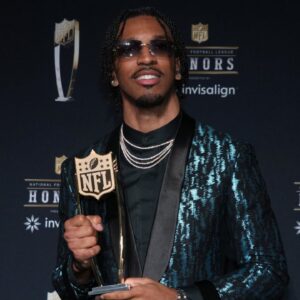 Washington Commanders quarterback Jayden Daniels poses with the Offensive Rookie of the Year award during Super Bowl LIX NFL Honors at Saenger Theatre.