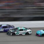 NASCAR Cup Series drivers Shane van Gisbergen (88) Brad Keselowski (6) and driver Bubba Wallace (23) race down the main straightaway during stage three of the FireKeepers Casino 400 at Michigan International Speedway.