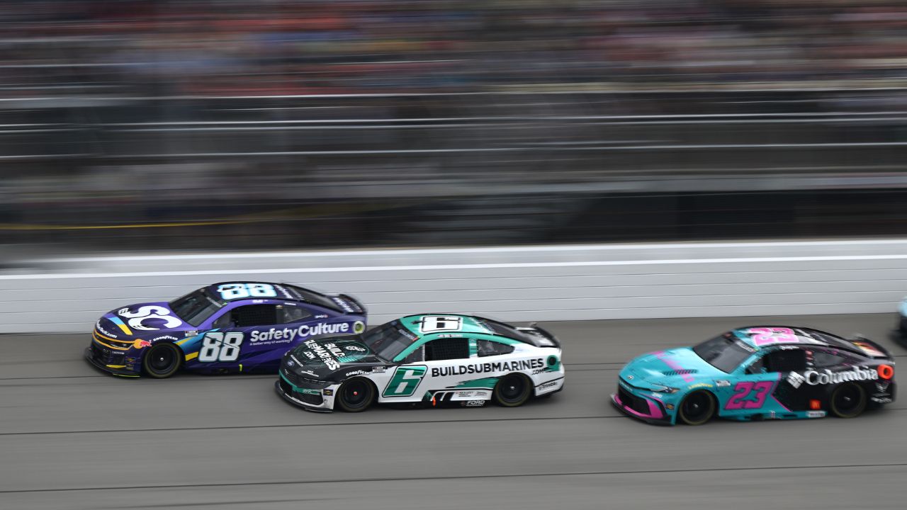 NASCAR Cup Series drivers Shane van Gisbergen (88) Brad Keselowski (6) and driver Bubba Wallace (23) race down the main straightaway during stage three of the FireKeepers Casino 400 at Michigan International Speedway.