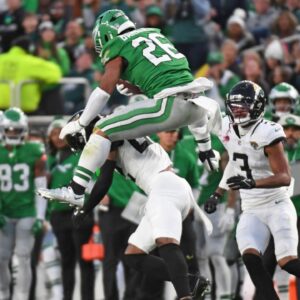 Philadelphia Eagles running back Saquon Barkley (26) jumps over Jacksonville Jaguars cornerback Jarrian Jones (22) during the second quarter at Lincoln Financial Field.