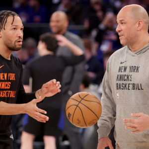 New York Knicks guard Jalen Brunson (11) warms up with assistant coach Rick Brunson (right)