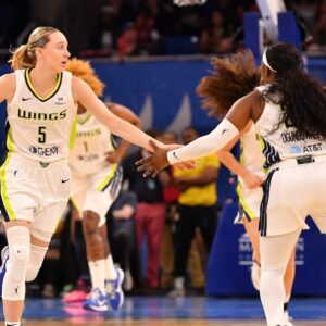 May 29, 2025; Chicago, Illinois, USA; Dallas Wings guard Paige Bueckers (5) celebrates with guard Arike Ogunbowale (24) during the first half against the Chicago Sky at the Wintrust Arena. Mandatory Credit: Patrick Gorski-Imagn Images